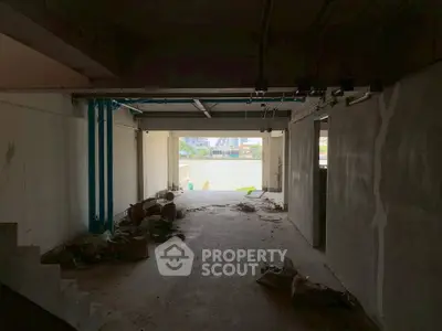 Spacious unfinished interior with potential river view in urban setting