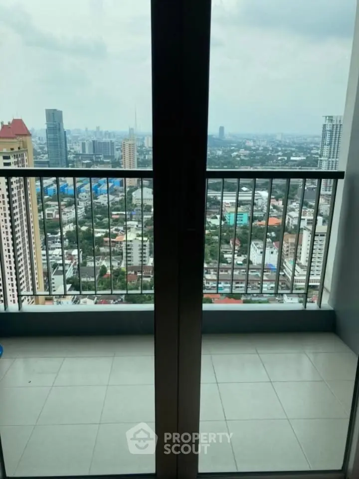 Stunning cityscape view from high-rise balcony with sleek railing design.
