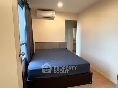 Modern bedroom with cozy bed and air conditioning, perfect for relaxation.