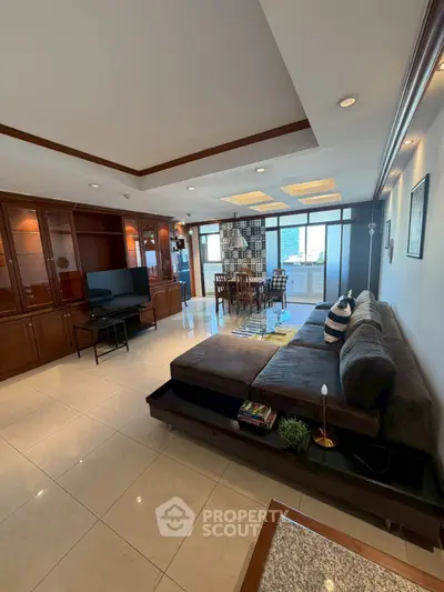 Spacious living room with modern decor and large windows offering natural light.