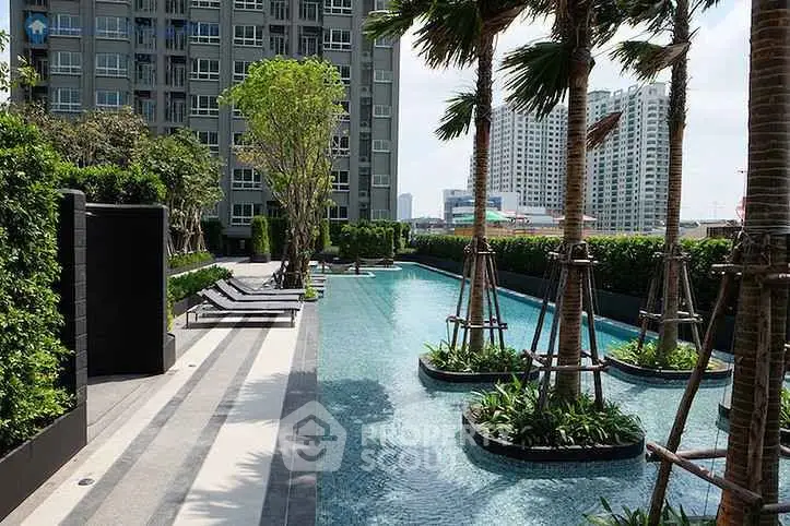 Luxurious condominium pool area with lush greenery and modern design.