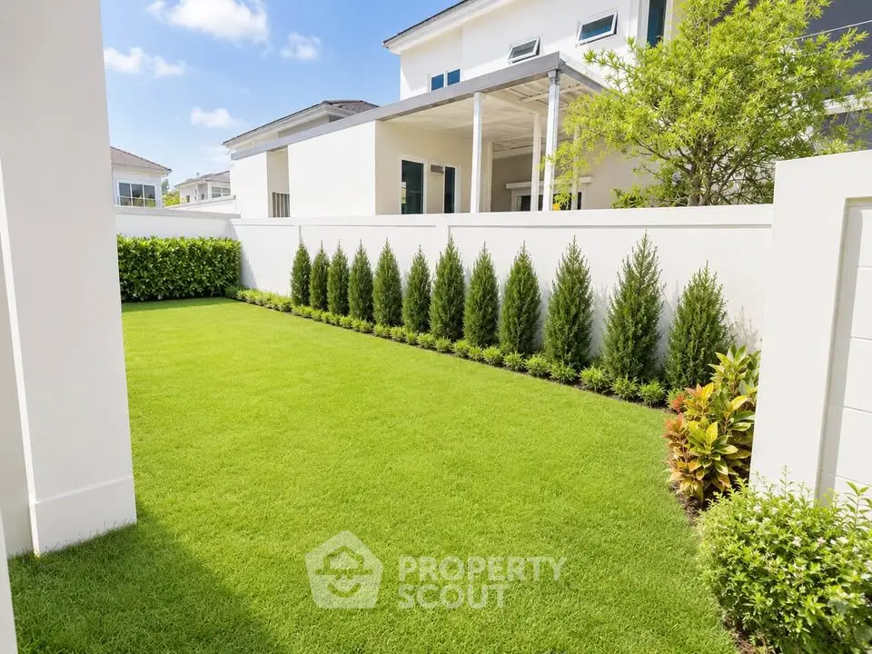Luxurious modern home with pristine garden and lush greenery, perfect for outdoor relaxation and entertainment.