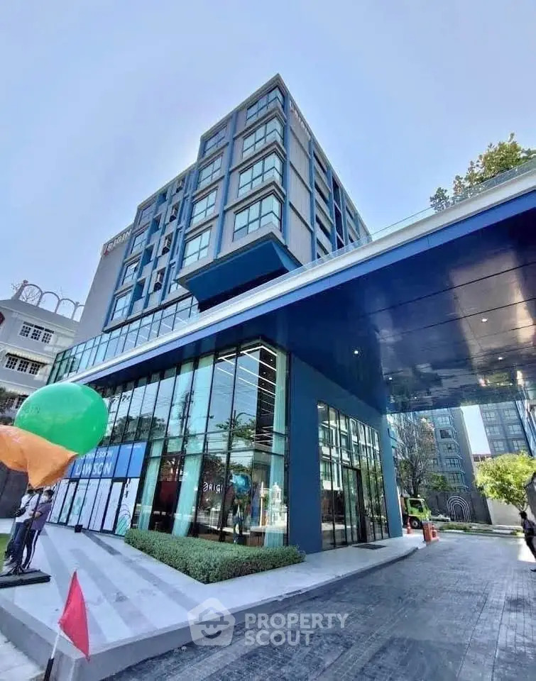 Modern high-rise building exterior with glass facade and sleek design