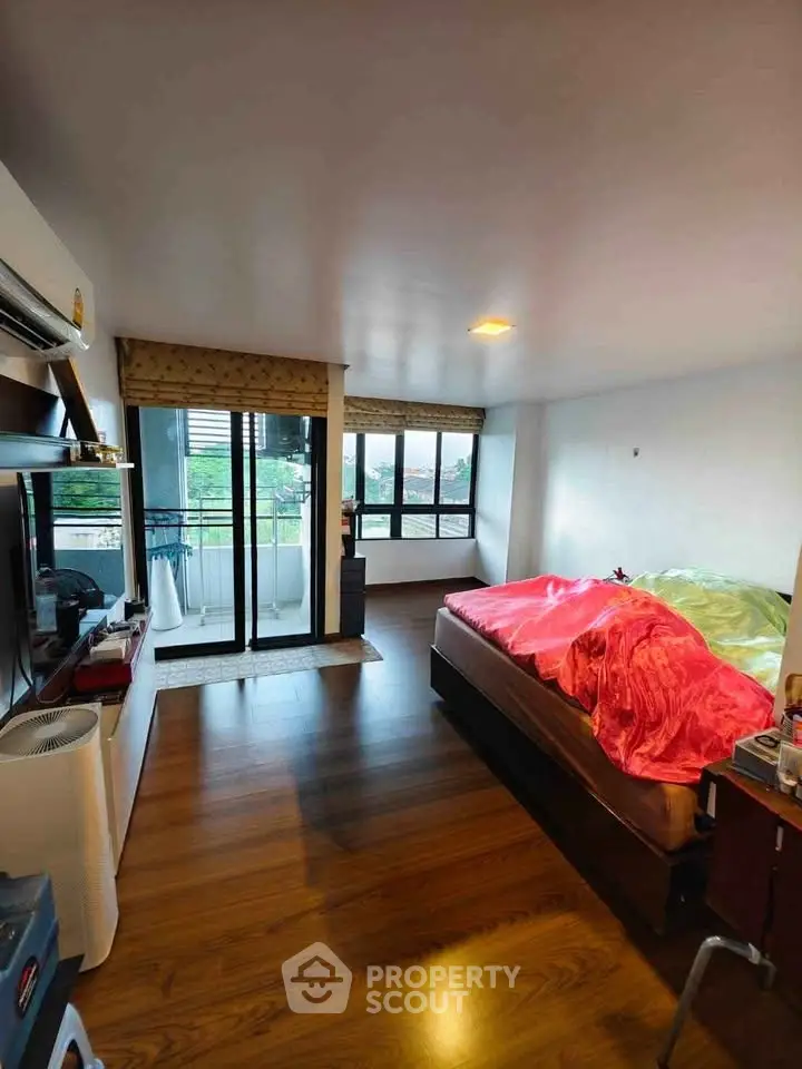 Spacious bedroom with balcony access and modern decor