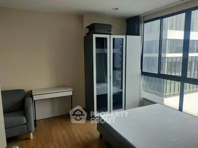 Modern bedroom with large windows and minimalist furniture in urban apartment