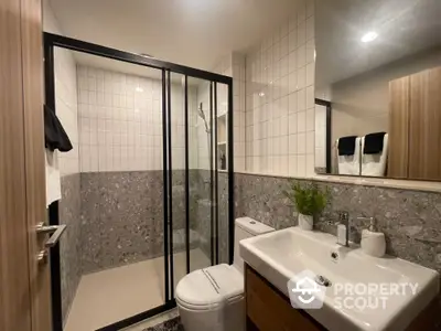 Modern bathroom with sleek shower and stylish sink in contemporary apartment