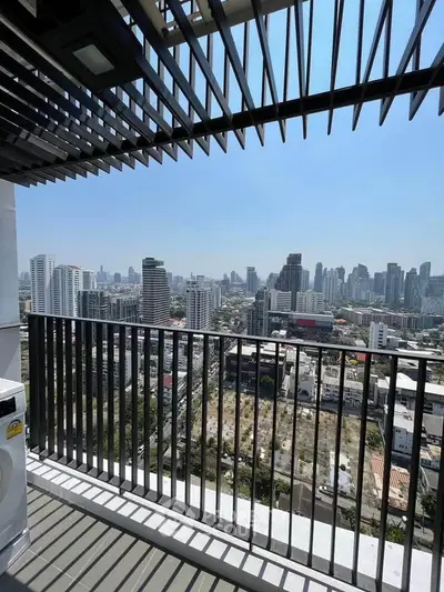 Stunning cityscape view from a modern balcony with sleek railing design.