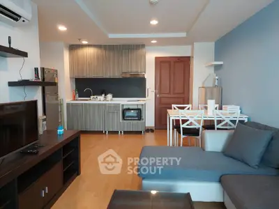 Modern living room with open kitchen and stylish furniture in cozy apartment