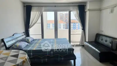 Spacious bedroom with balcony access and city view, featuring modern furnishings and natural light.