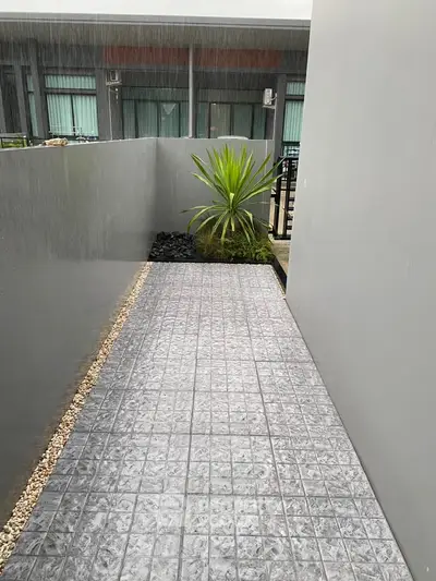Modern exterior walkway with sleek tiles and minimalist landscaping.