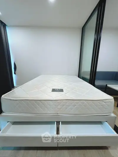 Modern bedroom with storage bed and glass partition, perfect for urban living.