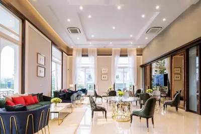 Luxurious living room with elegant decor and large windows offering natural light.