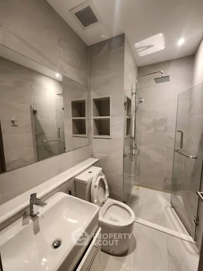 Modern bathroom with sleek fixtures and glass shower enclosure