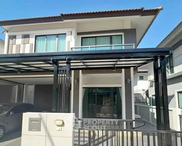 Modern two-story house with carport and sleek design in a suburban neighborhood.