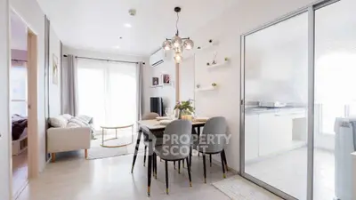 Modern dining area with elegant lighting and open layout in a bright apartment.