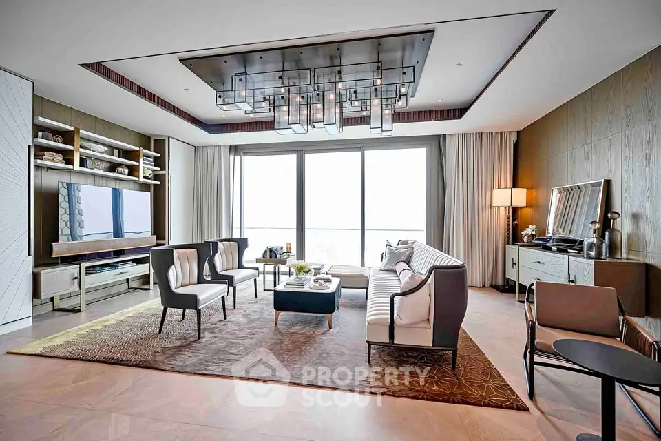 Luxurious modern living room with elegant furniture and large windows offering natural light.