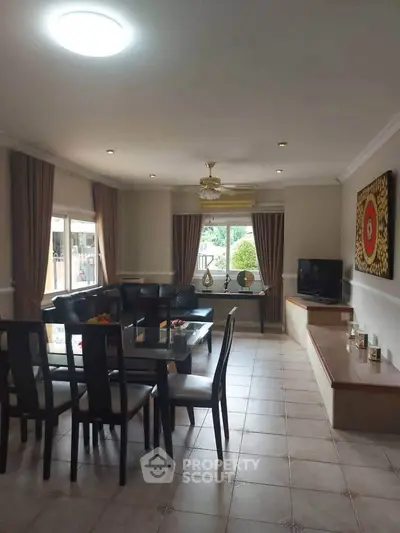 Spacious living room with elegant dining area and large windows for natural light.