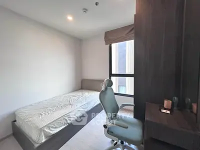 Modern minimalist bedroom with single bed and study desk, perfect for urban living.
