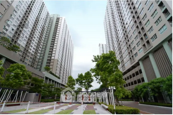 Modern high-rise residential buildings with lush greenery and spacious courtyard
