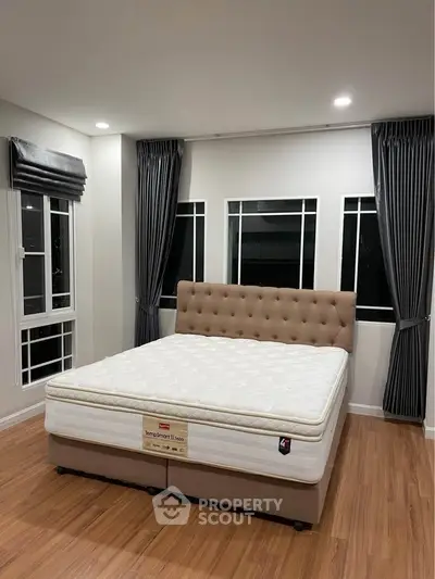 Spacious bedroom with elegant bed and modern decor, perfect for a cozy retreat.