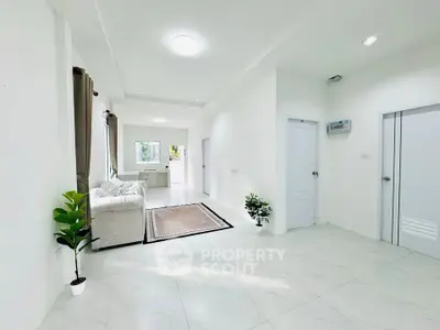 Spacious modern living room with white interiors and natural light