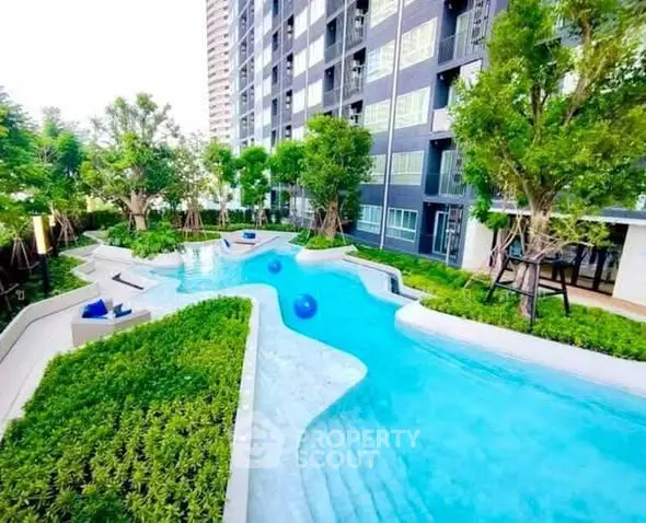 Luxurious apartment complex with stunning outdoor pool and lush greenery.