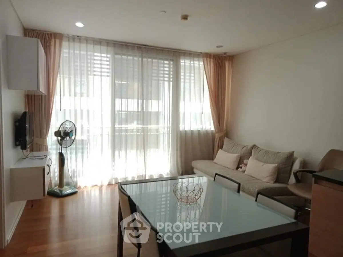 Spacious living room with modern decor and large windows for natural light