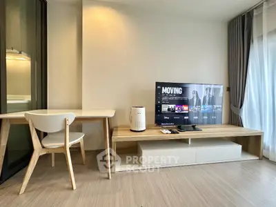 Modern living room with sleek furniture and entertainment setup in a stylish apartment.
