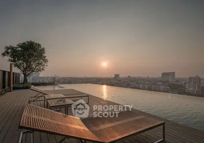 Stunning rooftop infinity pool with panoramic city views at sunset, perfect for luxury living.