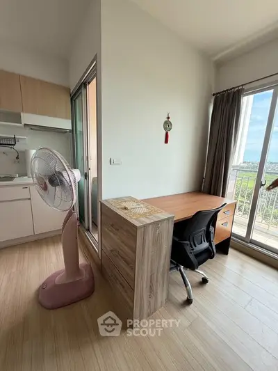 Modern apartment with study area and kitchen, featuring a balcony with a view.