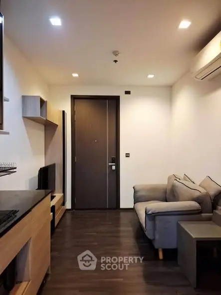 Modern living room with sleek design and cozy seating in a contemporary apartment.