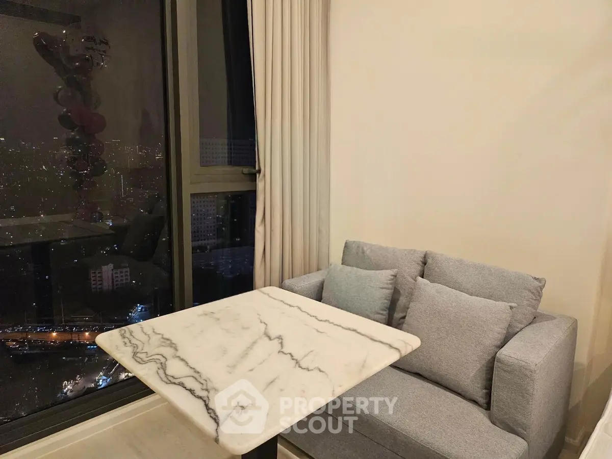 Cozy living room with marble table and city view at night