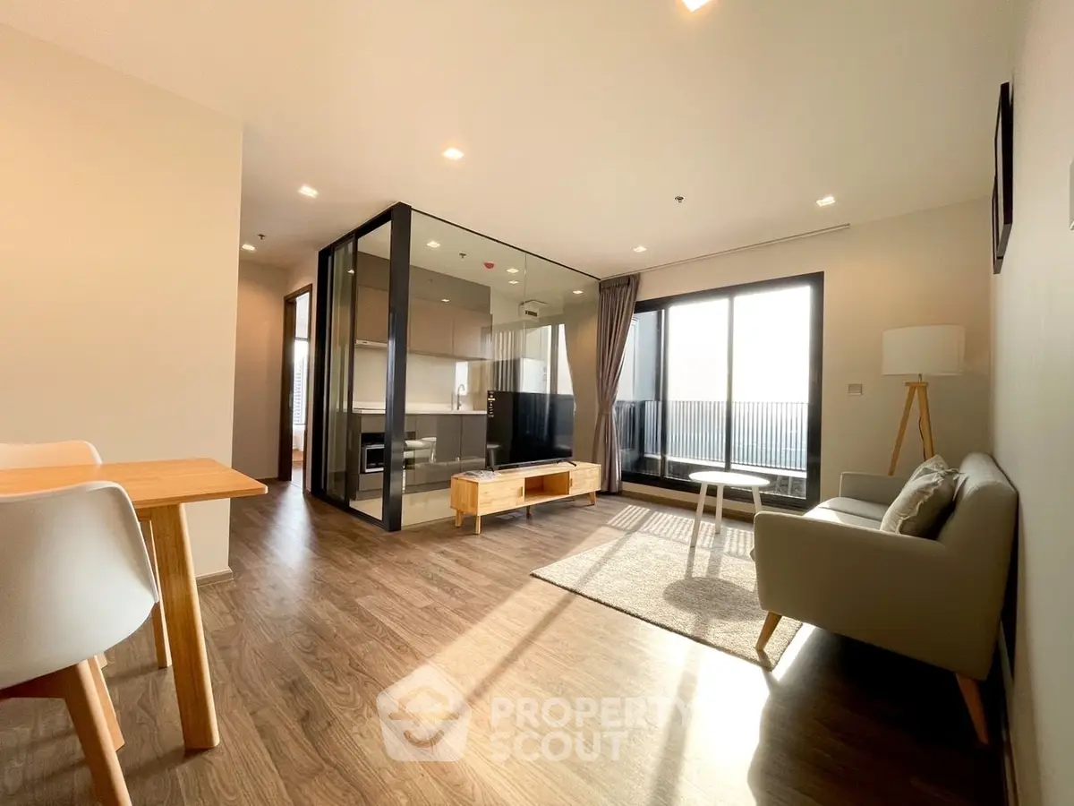 Spacious modern living room with open layout and large windows offering natural light.