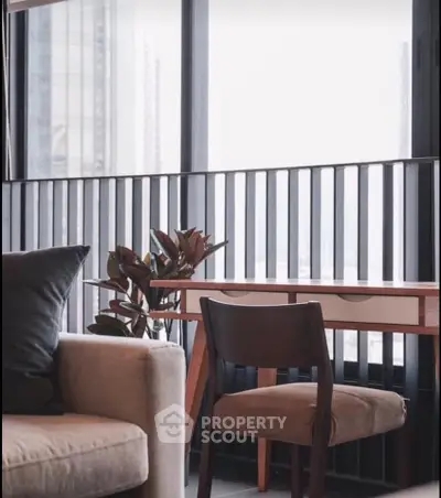 Modern living room with stylish furniture and large windows offering city views.