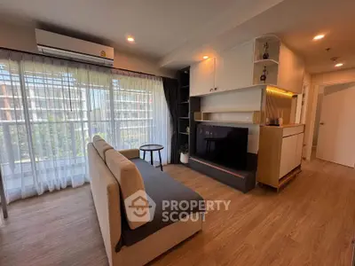 Modern living room with large windows and stylish furniture in a contemporary apartment.