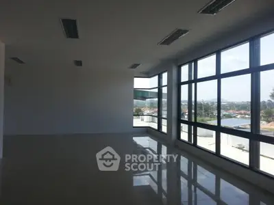 Spacious office space with large windows offering panoramic city views