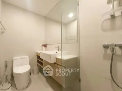 Modern bathroom with glass shower and sleek wooden vanity