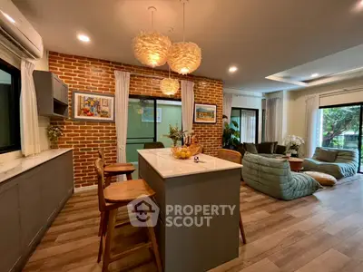 Spacious open-layout living room with modern kitchen island and stylish decor