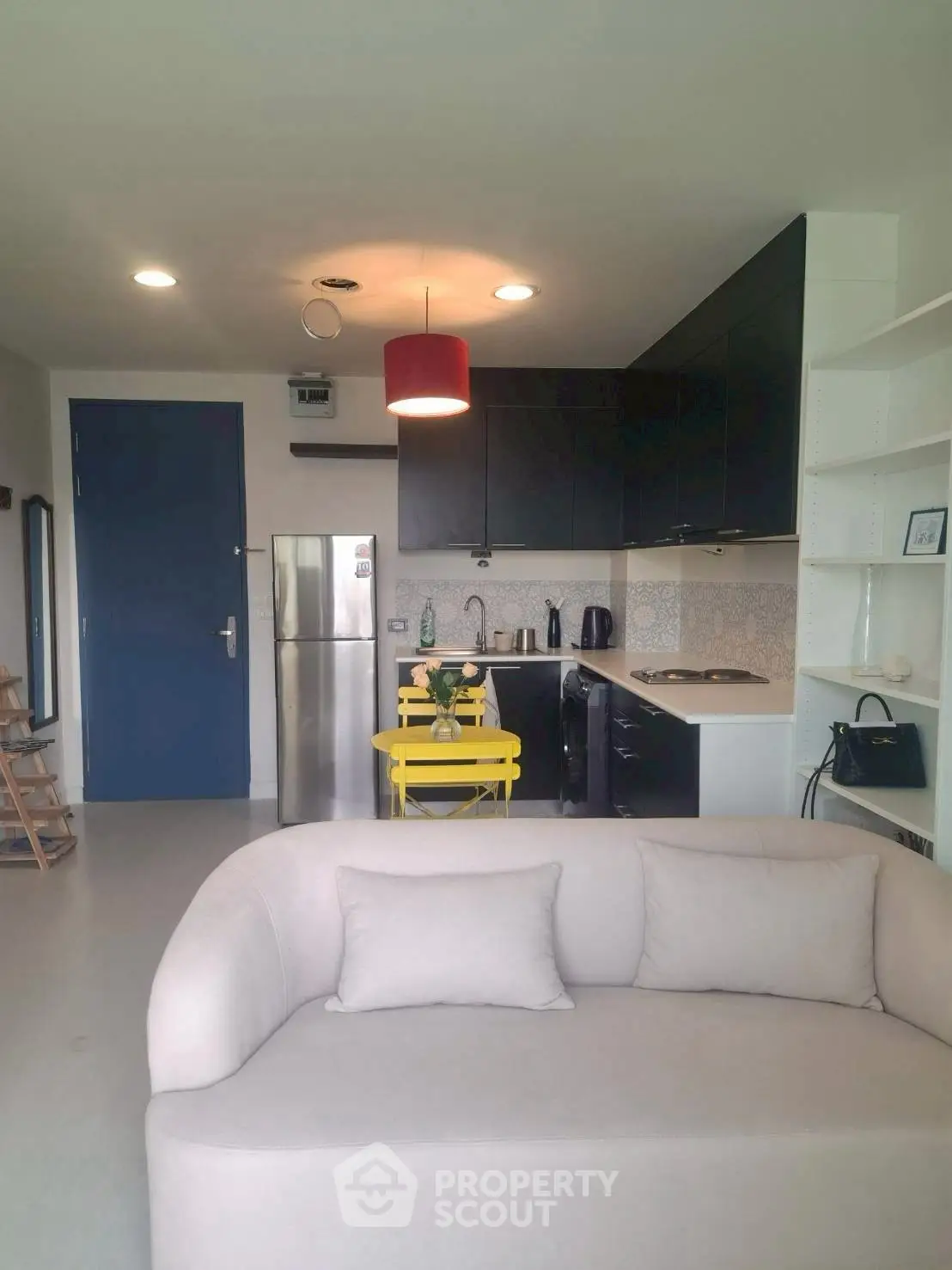 Modern open-layout kitchen with cozy living area and stylish decor