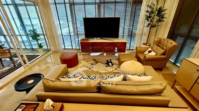 Luxurious living room with modern decor, large windows, and stylish furniture in a high-end apartment.