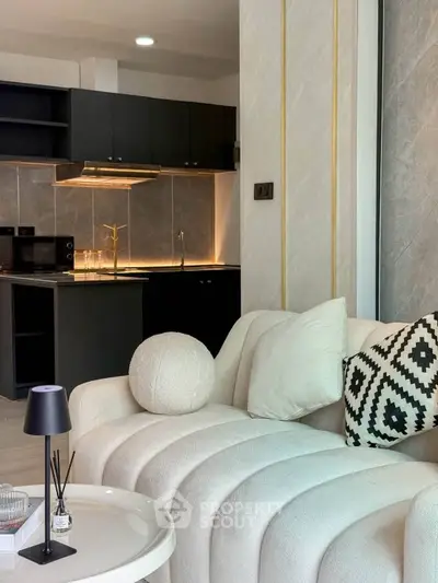 Modern open-layout living room with stylish kitchen and elegant decor