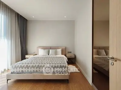 Modern bedroom with stylish decor and large window for natural light