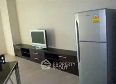 Modern living room with sleek TV stand and stainless steel fridge