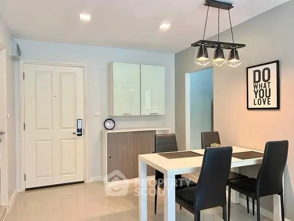 Modern dining area with sleek furniture and motivational decor in a stylish apartment.