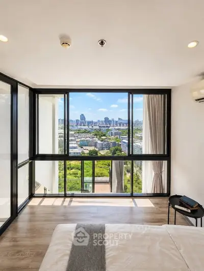 Stunning bedroom with floor-to-ceiling windows offering panoramic city views.