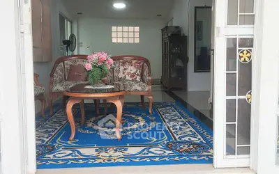 Charming living room with elegant furniture and vibrant blue rug, perfect for cozy gatherings.