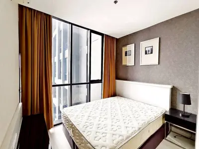 Modern bedroom with large window and stylish decor in urban apartment
