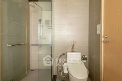 Modern bathroom with glass shower and sleek toilet design