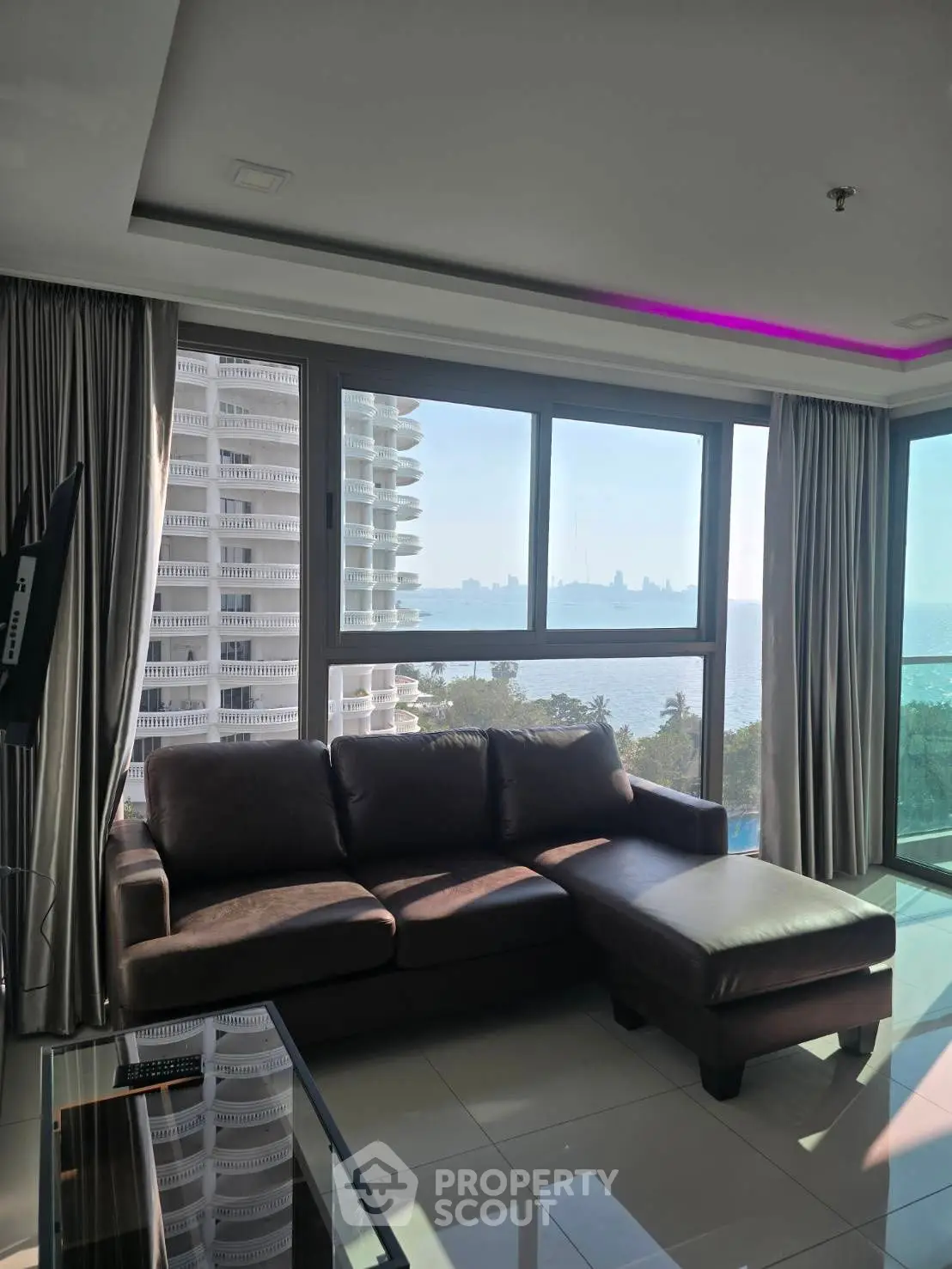 Luxurious living room with stunning ocean view and modern furnishings.