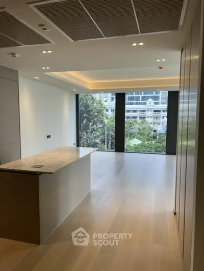 Spacious modern living room with large windows and city view